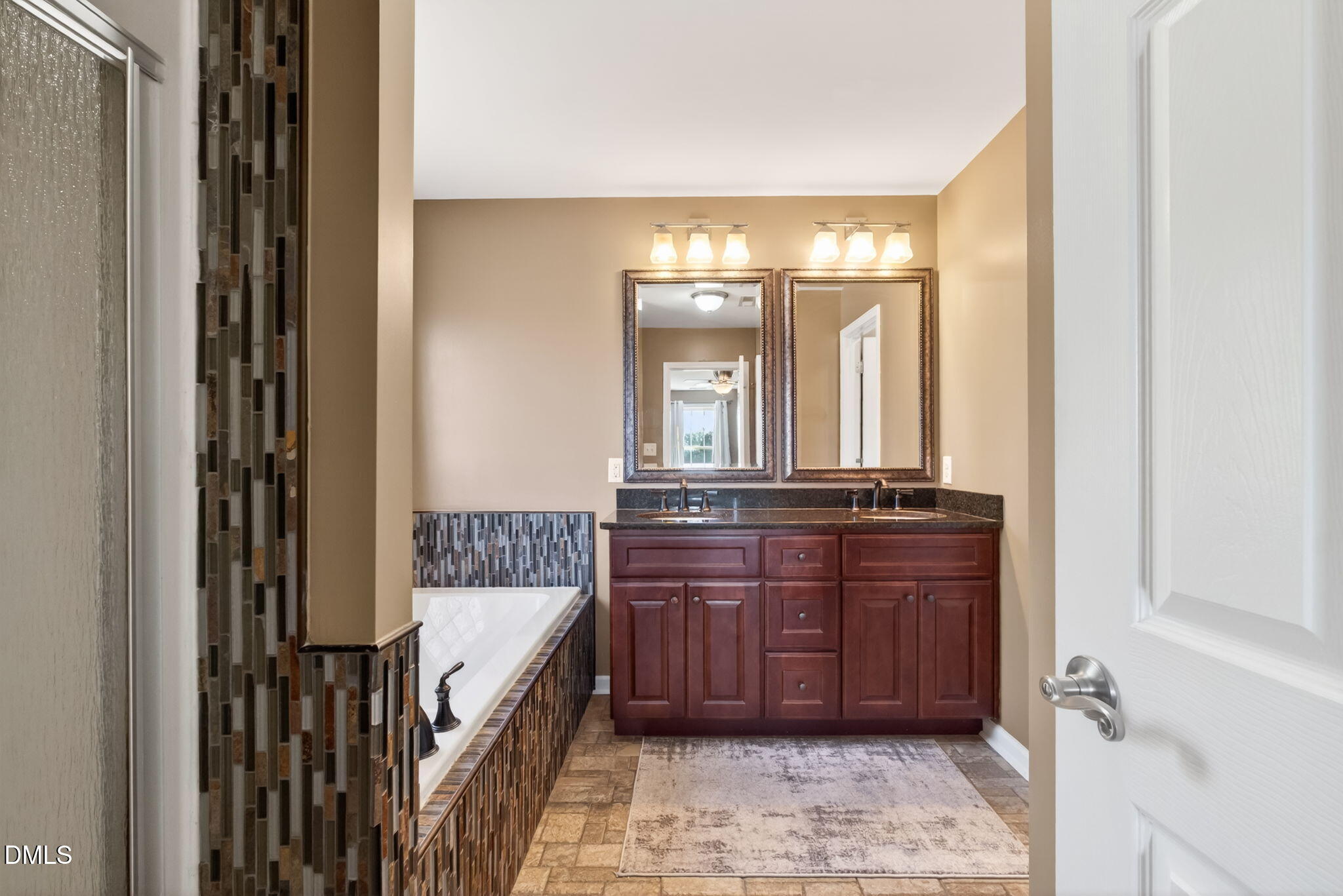 923 White Memorial Church Road Willow Spring, NC 27592 - Photo 26 of 46 a bathroom with a bathtub a double vanity sink and a mirror