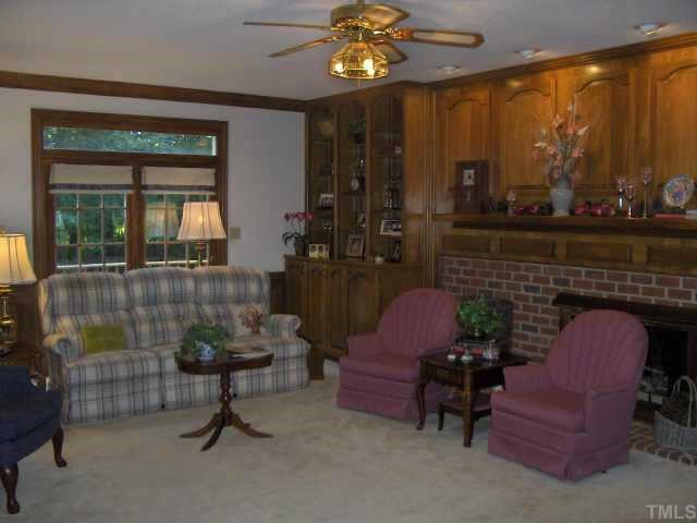 3011 Eubanks Road Durham, NC 27707 - Photo 4 of 10 Family Room w/ dual burning fireplace, built in bookshelves, heavy molding & more!