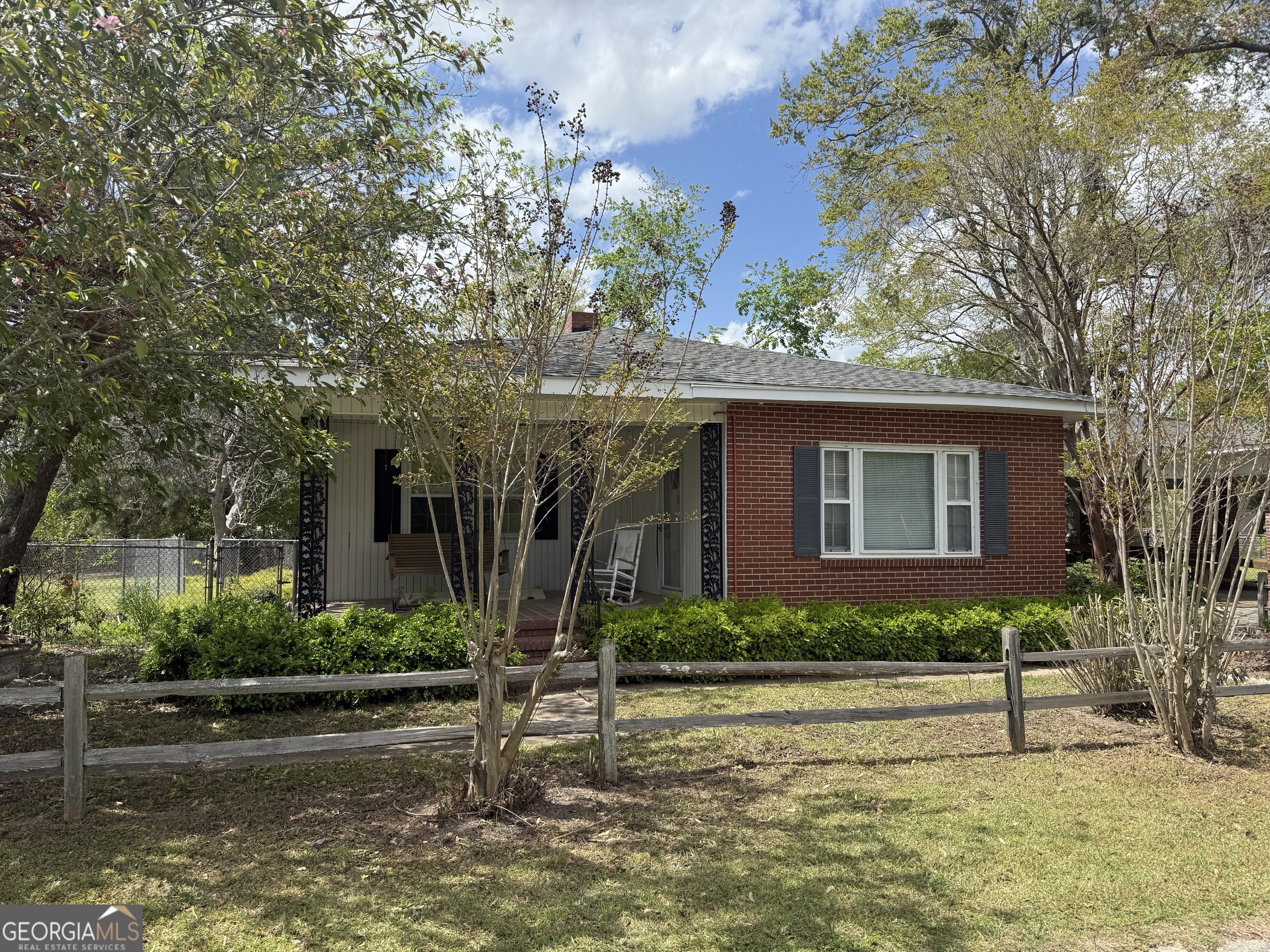a front view of a house with a garden