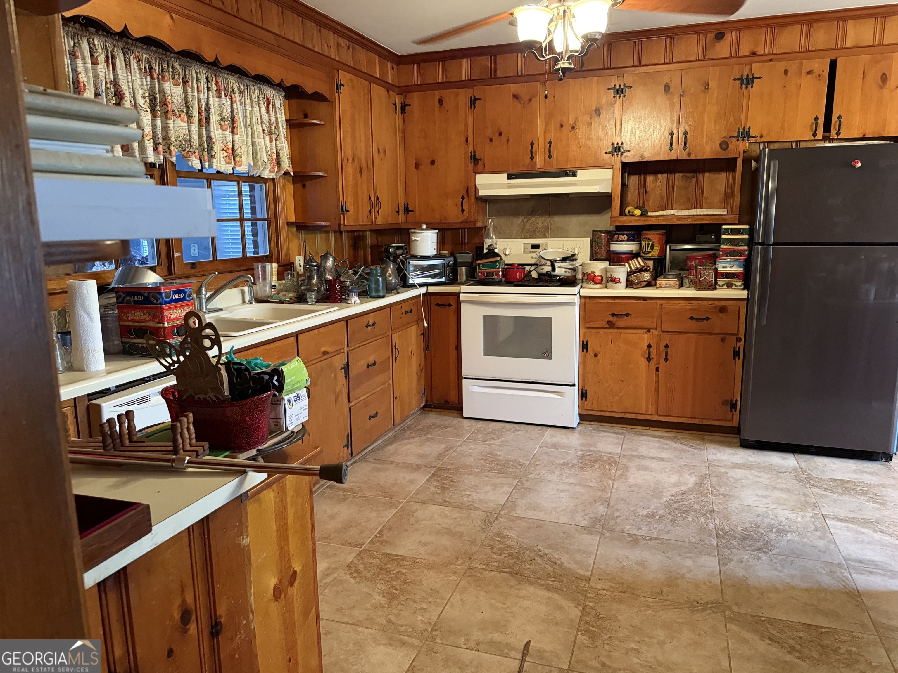 641 South Masonic Street Millen, GA 30442 - Photo 11 of 20 a kitchen with stainless steel appliances a stove a sink and cabinets