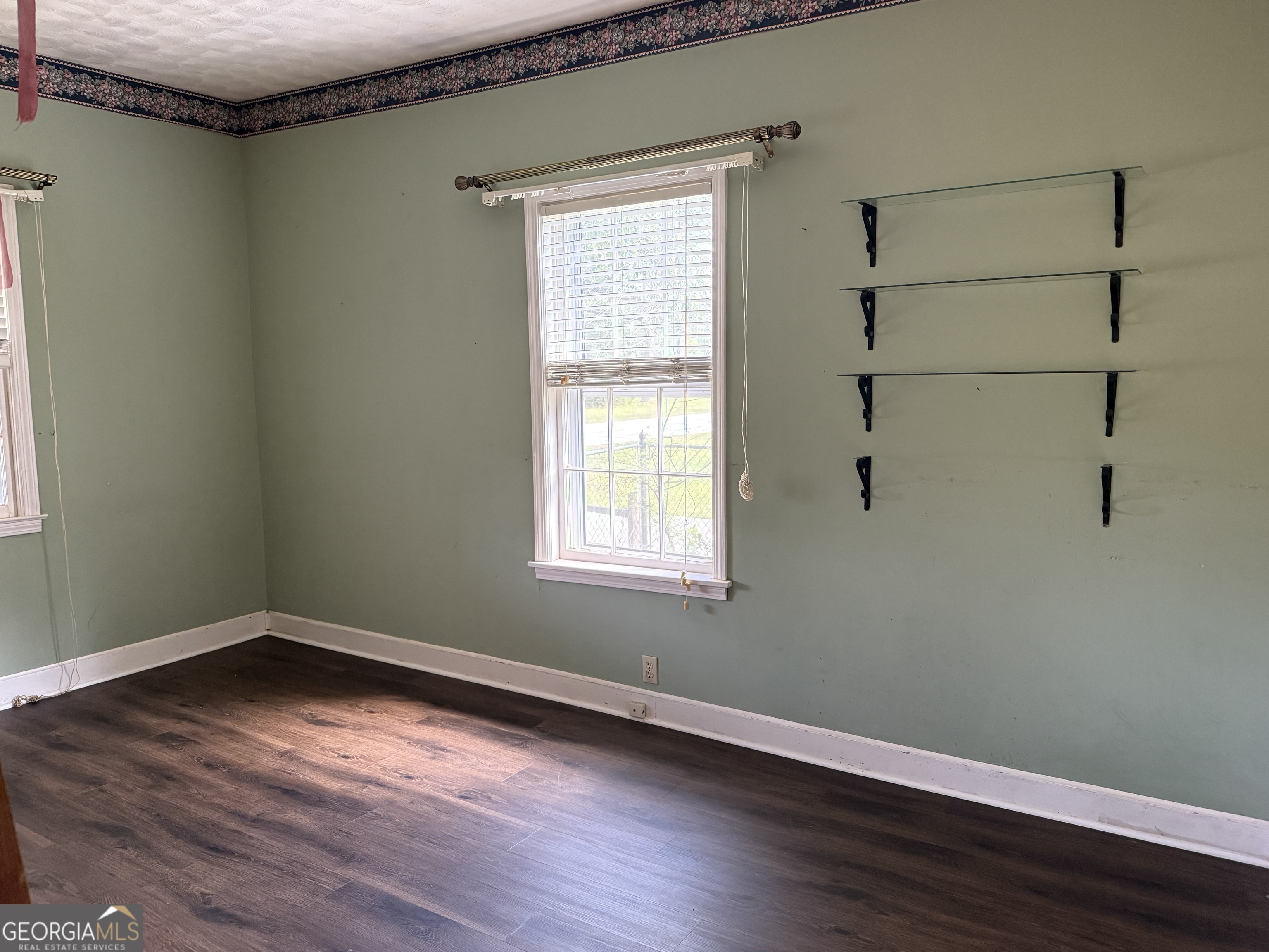 641 South Masonic Street Millen, GA 30442 - Photo 13 of 20 a view of a room with wooden floor and windows