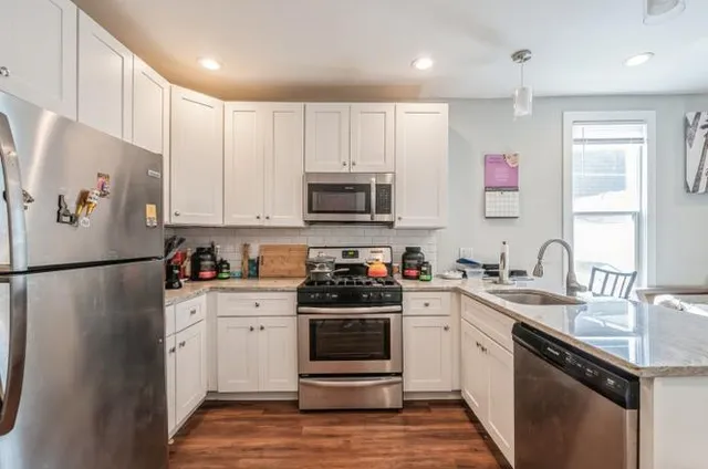 a kitchen with a sink a stove and refrigerator