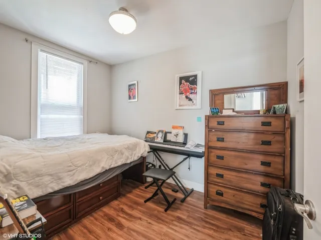a bedroom with a bed and a dresser