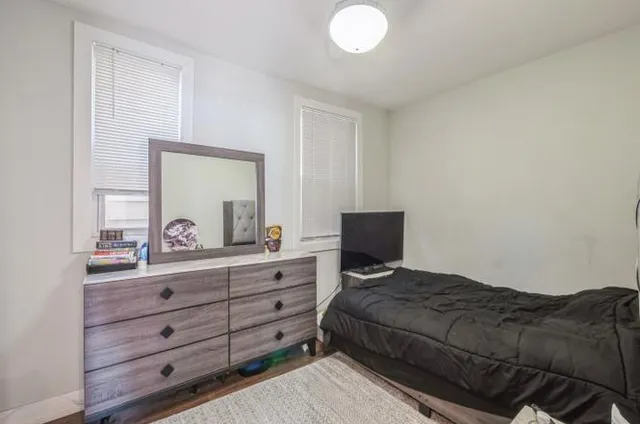 a bedroom with a bed and a dresser