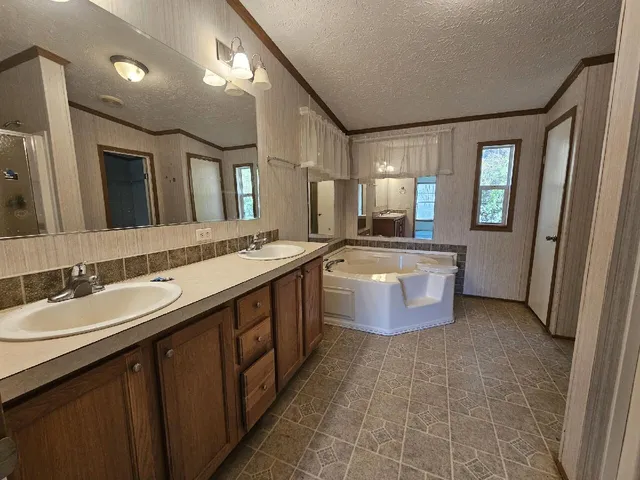 a large bathroom with a sink double vanity and a mirror
