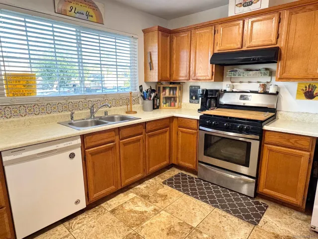a kitchen with a stove a sink and a microwave