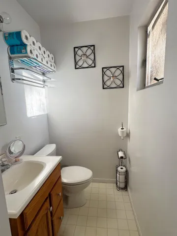 a bathroom with a sink mirror and toilet
