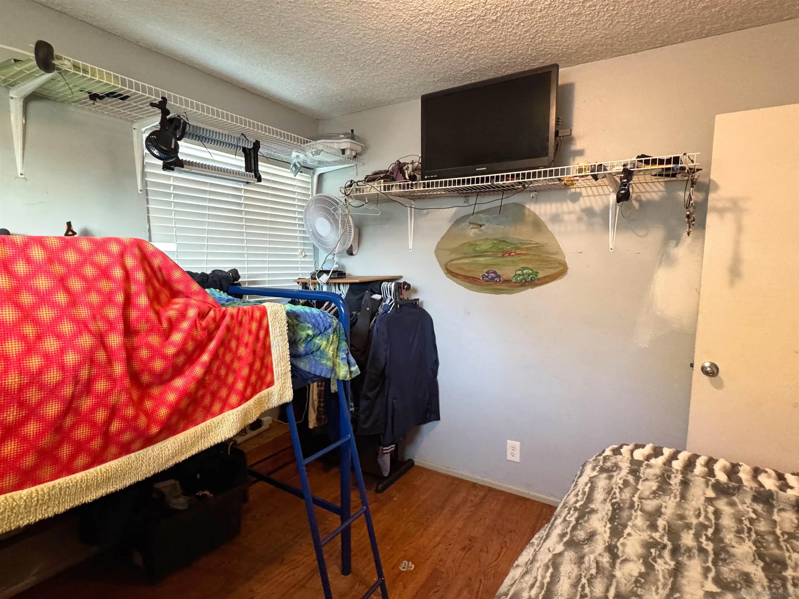 1117 Kings Road Escondido, CA 92027 - Photo 24 of 37 a bedroom with a bed and flat screen tv