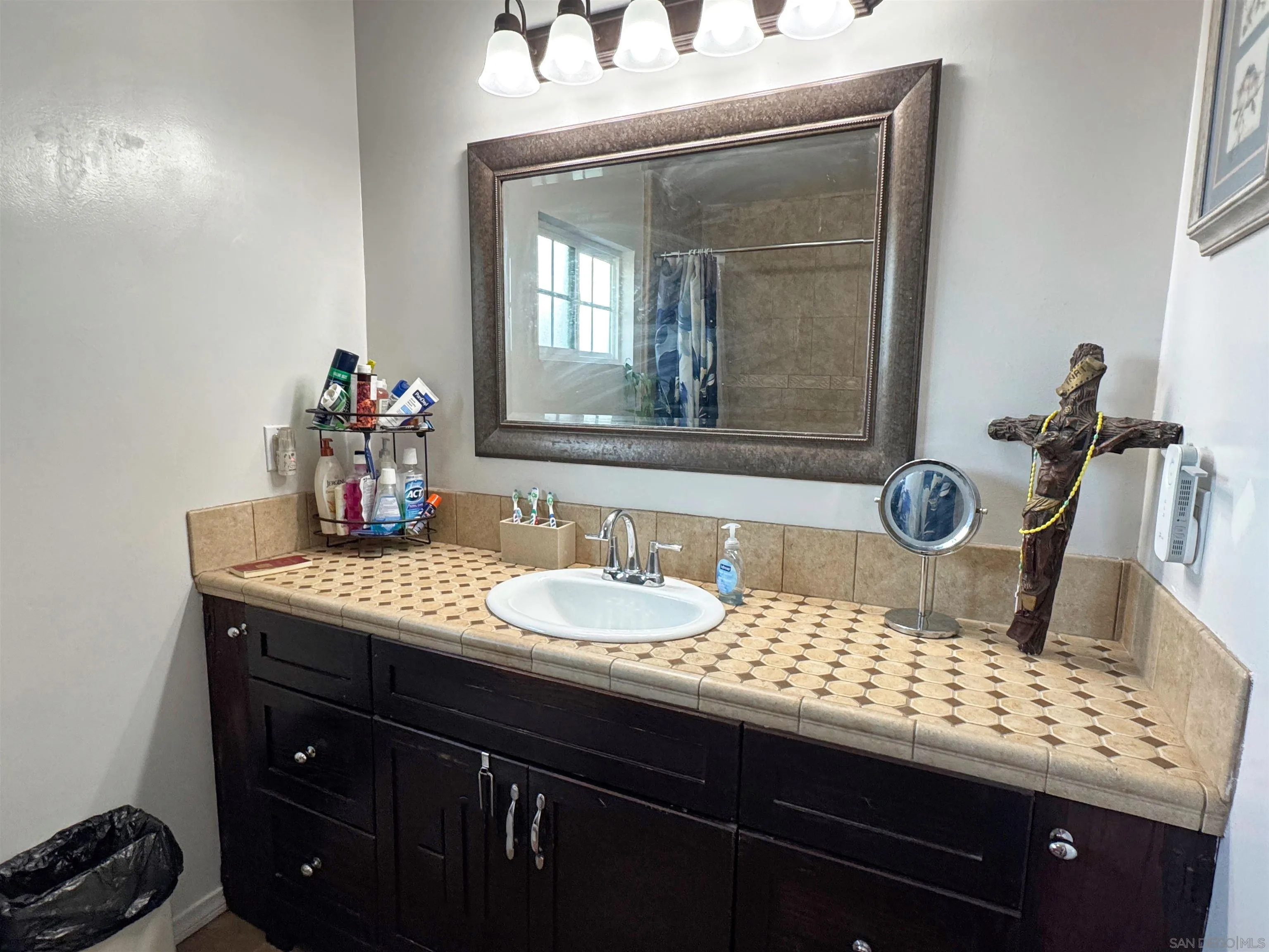 1117 Kings Road Escondido, CA 92027 - Photo 27 of 37 a bathroom with a granite countertop sink a mirror and a