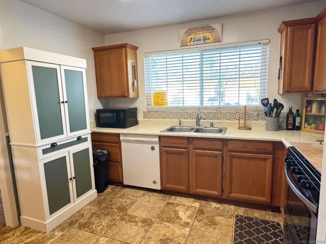 a kitchen with a sink cabinets and window
