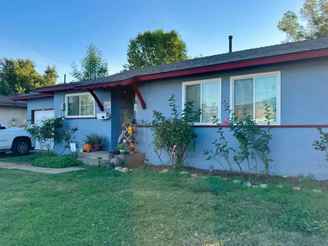 a front view of house with yard and green space