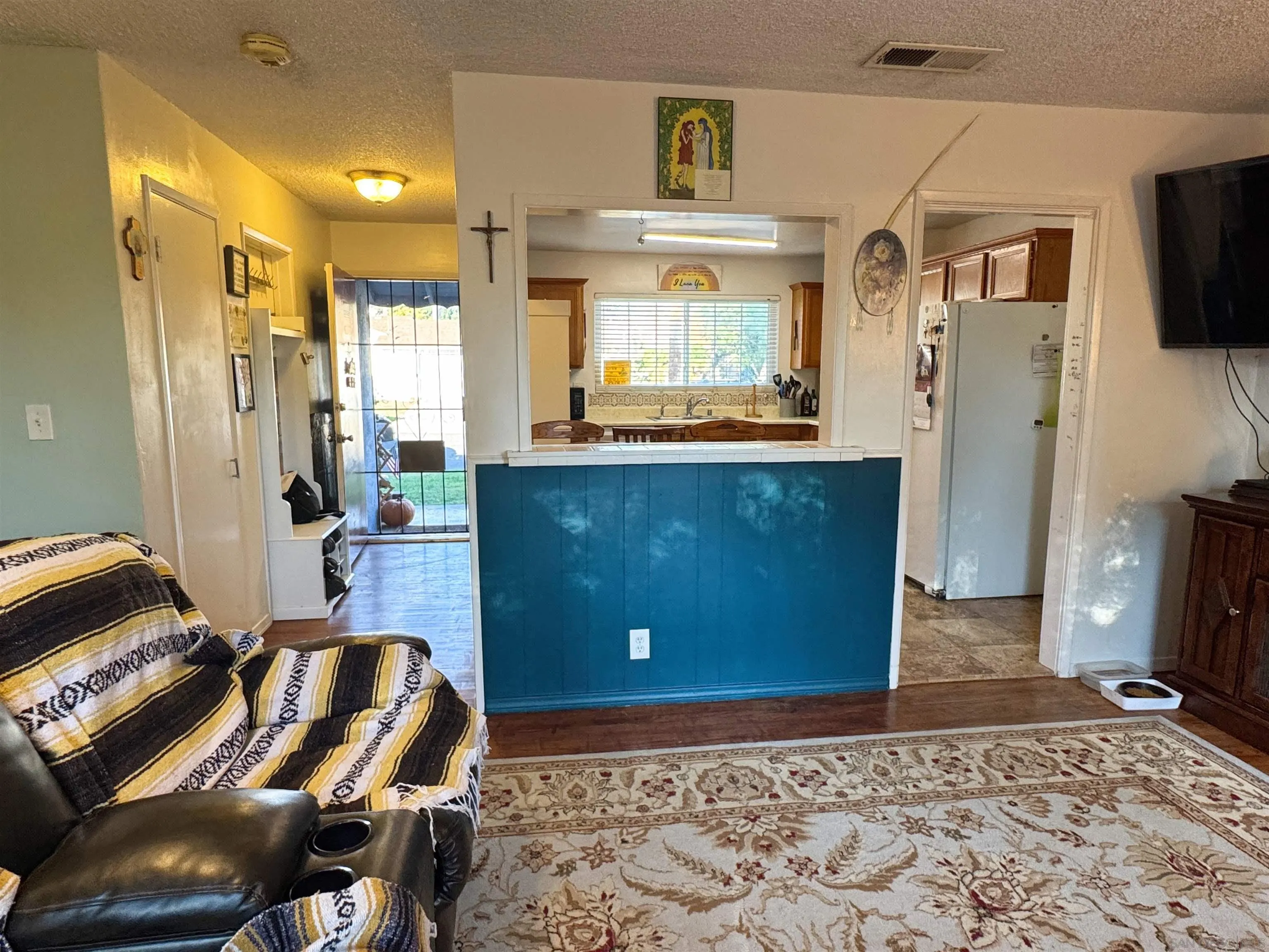 1117 Kings Road Escondido, CA 92027 - Photo 9 of 37 a living room with a couch and a flat screen tv