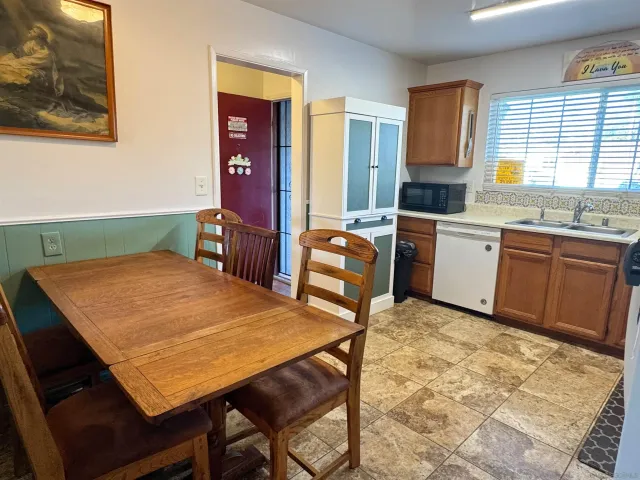 a kitchen with a wooden cabinets and chairs