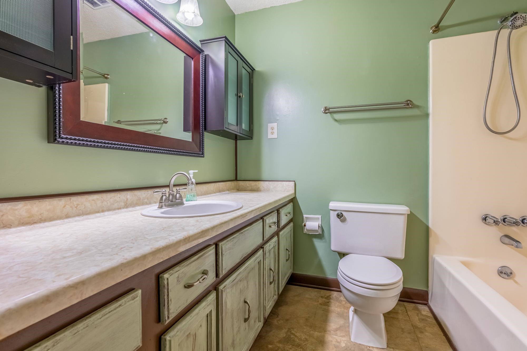 10860 Macedonia Road Brighton, TN 38011 - Photo 14 of 24 a bathroom with a granite countertop toilet sink and mirror