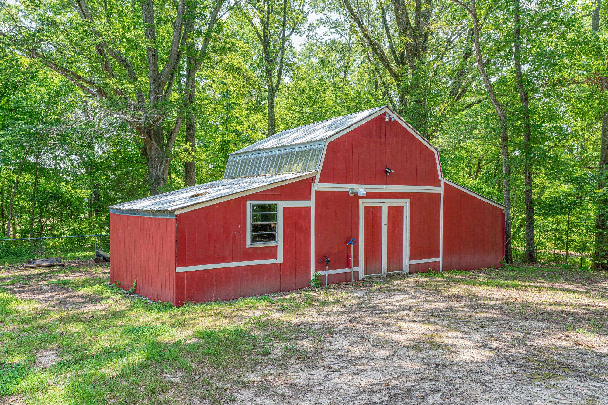 10860 Macedonia Road Brighton, TN 38011 - Photo 19 of 24 a view of a backyard with large trees and wooden fence