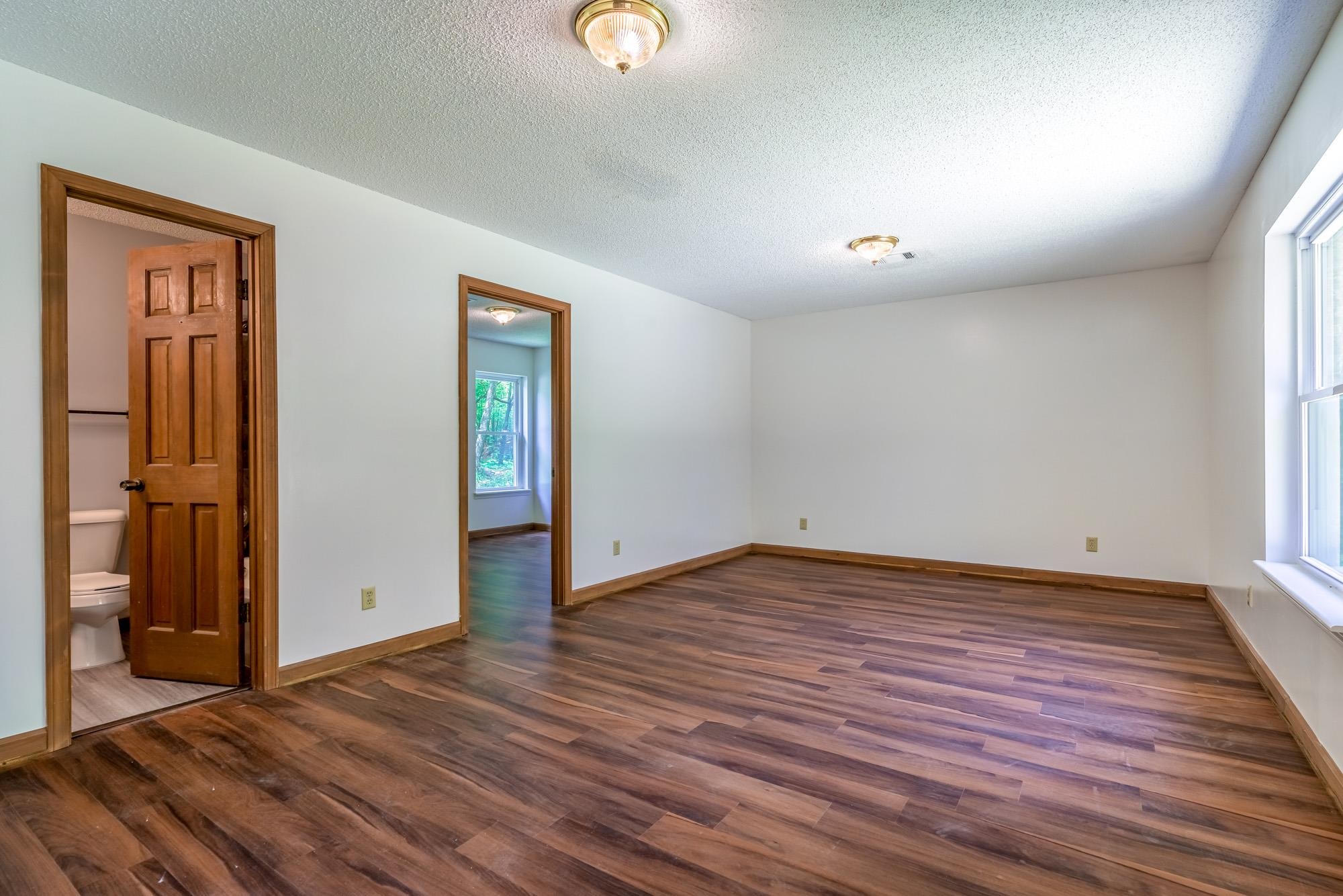 10860 Macedonia Road Brighton, TN 38011 - Photo 8 of 24 an empty room with wooden floor and windows