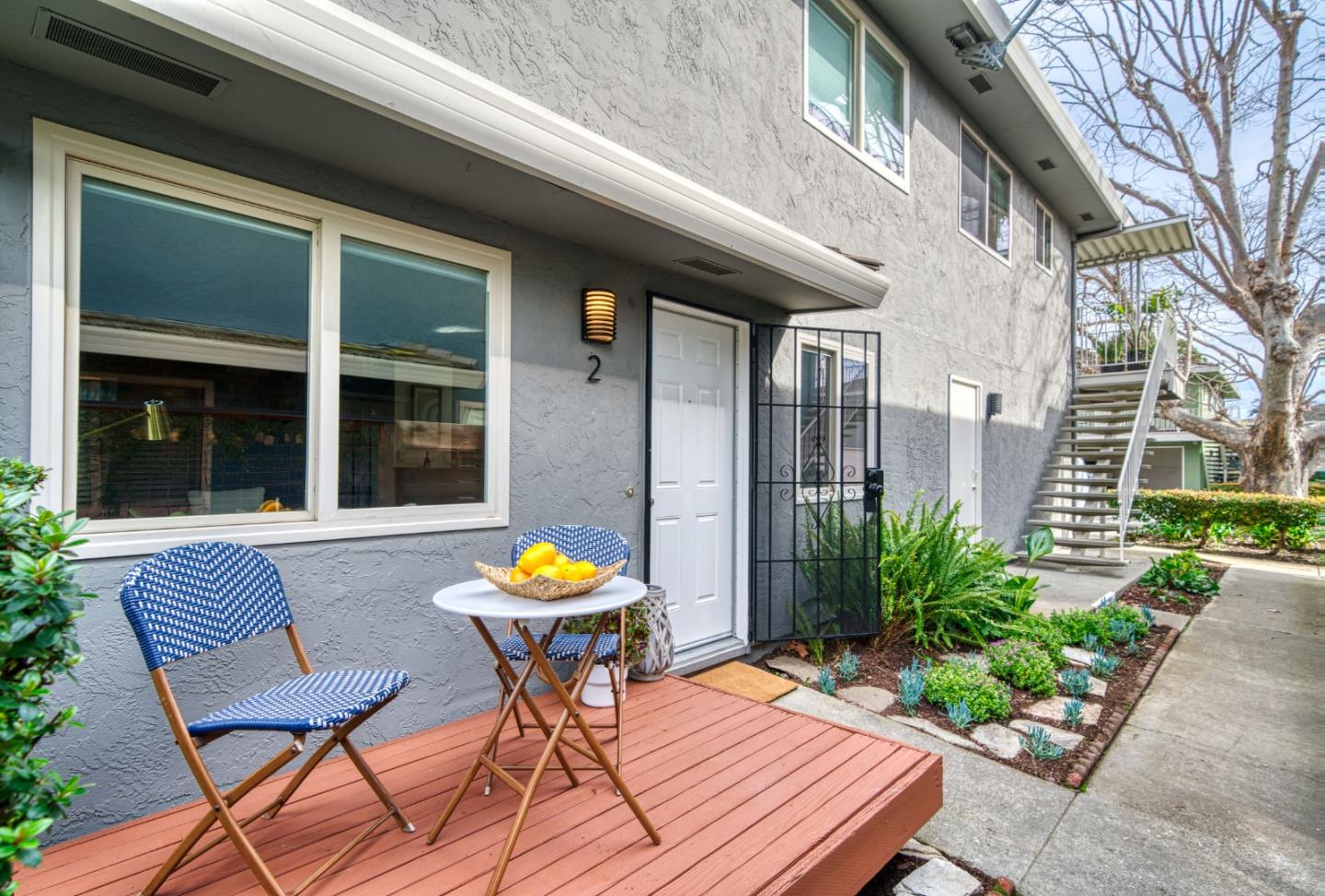 a view of a wooden chairs and table in the patio