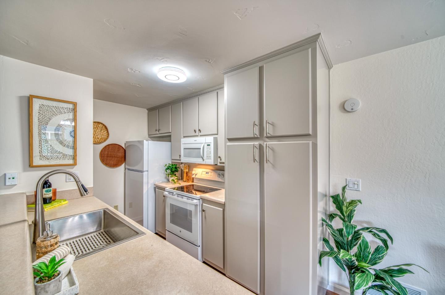 1380 Ruby Court, Unit 2 Capitola, CA 95010 - Photo 11 of 38 a kitchen with stainless steel appliances a refrigerator a sink a counter top space