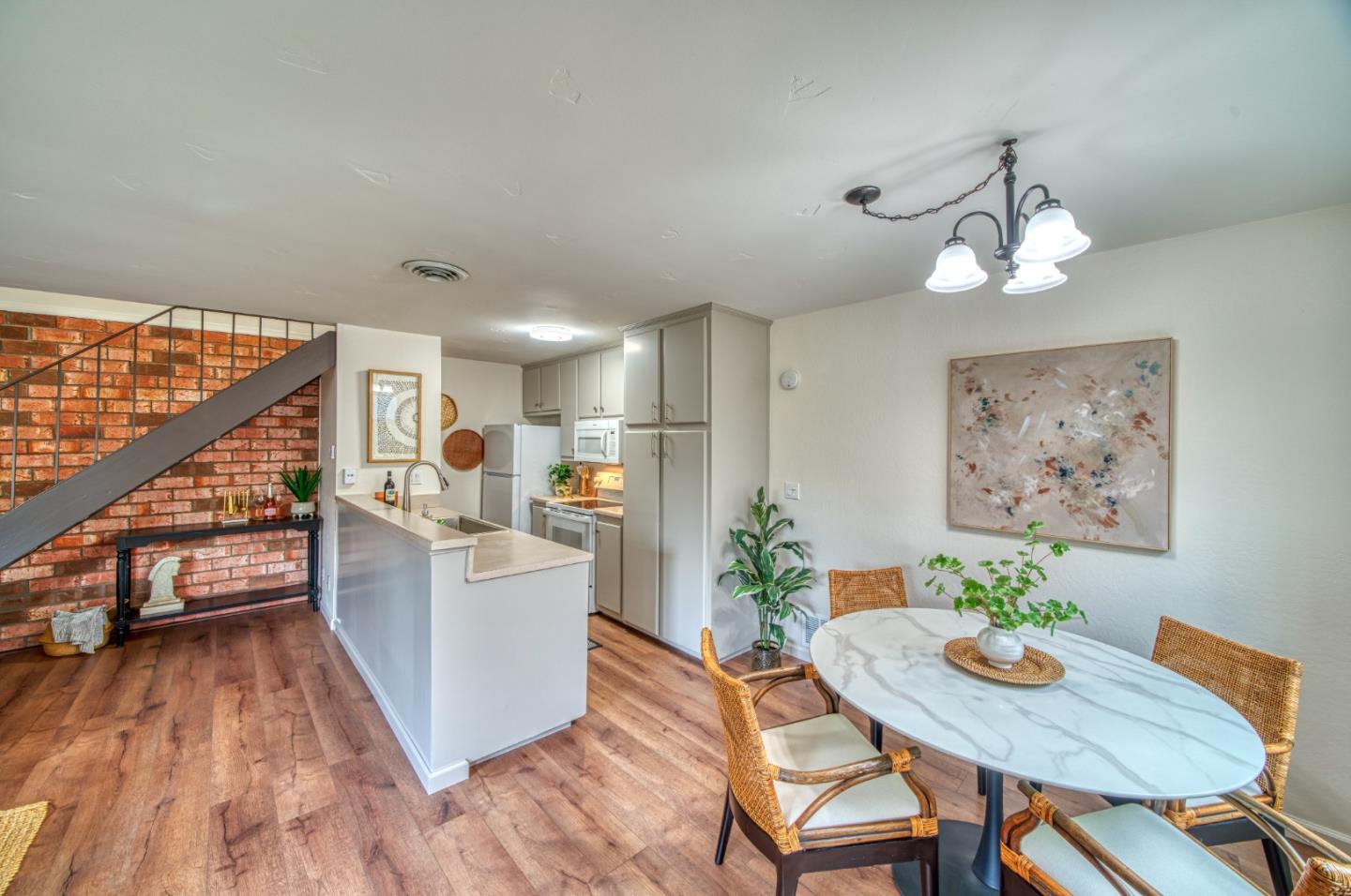 1380 Ruby Court, Unit 2 Capitola, CA 95010 - Photo 15 of 38 a view of a dining room with furniture wooden floor and a chandelier