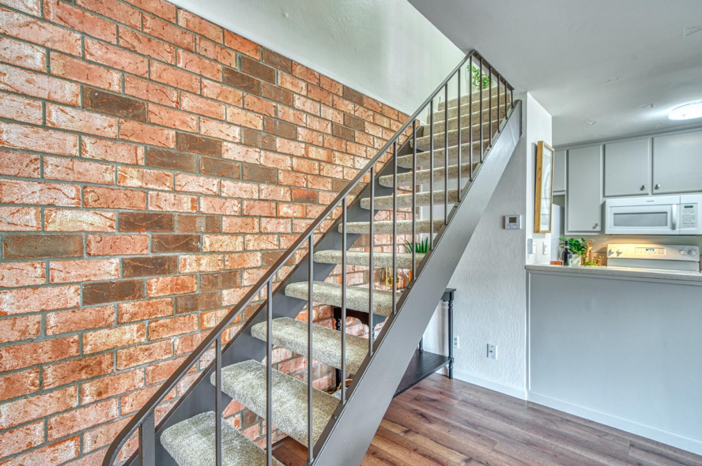 1380 Ruby Court, Unit 2 Capitola, CA 95010 - Photo 17 of 38 a picture of an empty room with wooden floor and stairs