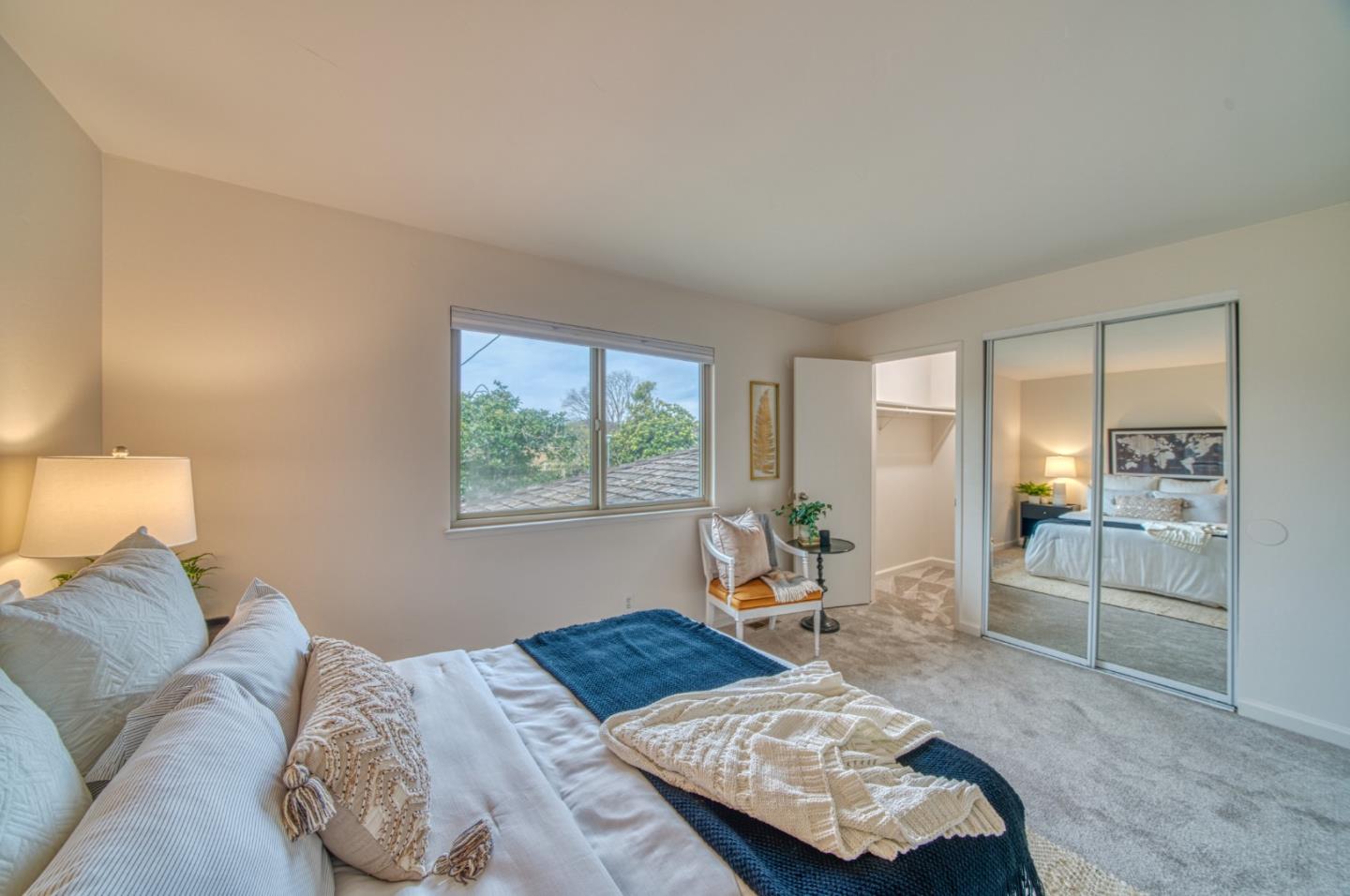 1380 Ruby Court, Unit 2 Capitola, CA 95010 - Photo 18 of 38 a bedroom with a bed and wooden floor