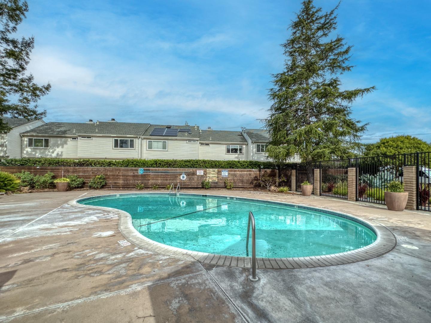 1380 Ruby Court, Unit 2 Capitola, CA 95010 - Photo 31 of 38 a view of a swimming pool with an outdoor seating and a yard