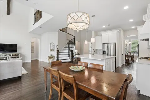 a large kitchen with a table and chairs