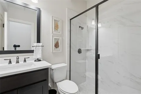 a bathroom with a sink toilet and shower