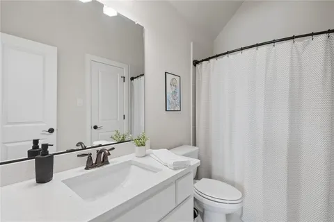 a bathroom with a double vanity sink and mirror