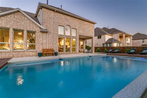 a view of a house with pool and a yard