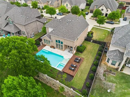 an aerial view of a house with pool outdoor seating and yard