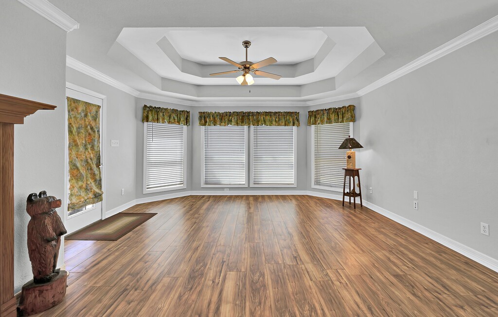 621 South Ruidoso Downs Drive Robinson, TX 76706 - Photo 15 of 41 wooden floor in an empty room with a window