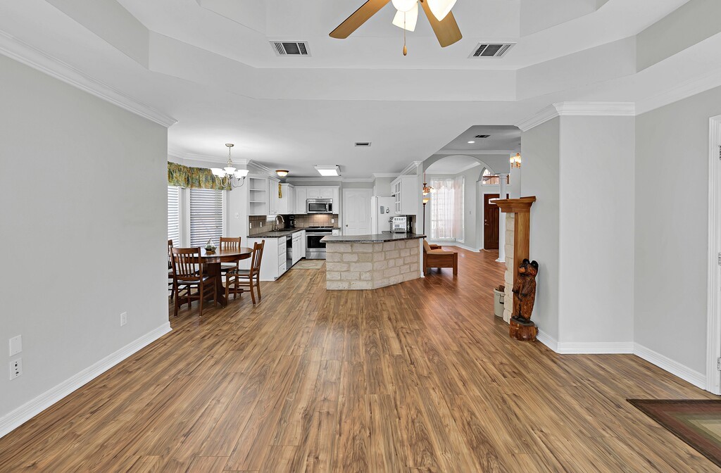 621 South Ruidoso Downs Drive Robinson, TX 76706 - Photo 16 of 41 a view of a kitchen with kitchen island wooden floors center island and stainless steel appliances