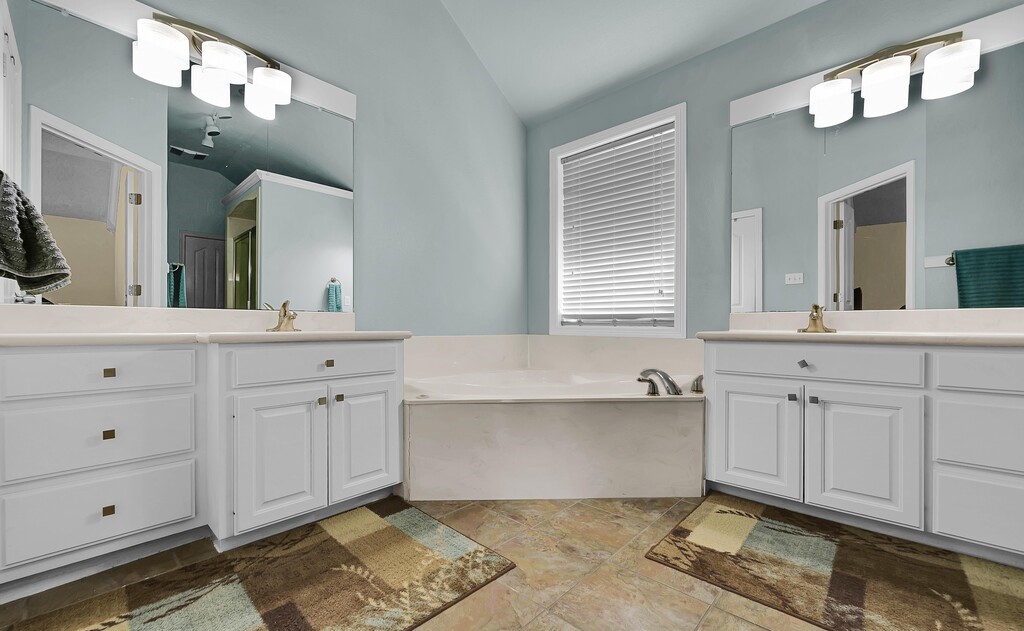621 South Ruidoso Downs Drive Robinson, TX 76706 - Photo 20 of 41 a spacious bathroom with a double vanity sink mirror and bathtub