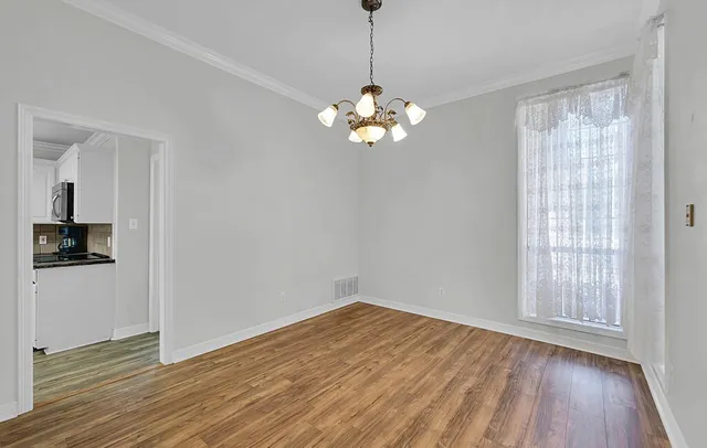 a large kitchen with granite countertop a sink and dishwasher a stove top oven with wooden floor