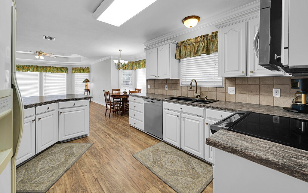 621 South Ruidoso Downs Drive Robinson, TX 76706 - Photo 9 of 41 a kitchen with granite countertop a sink stainless steel appliances and cabinets