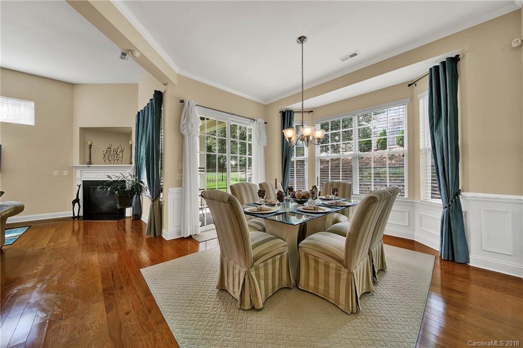 1336 Secret Path Drive Fort Mill, SC 29708 - Photo 11 of 27 a dining room with furniture wooden floor a chandelier and a rug