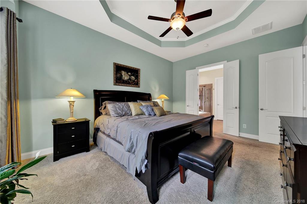 1336 Secret Path Drive Fort Mill, SC 29708 - Photo 14 of 27 a bedroom with a bed and a chandelier