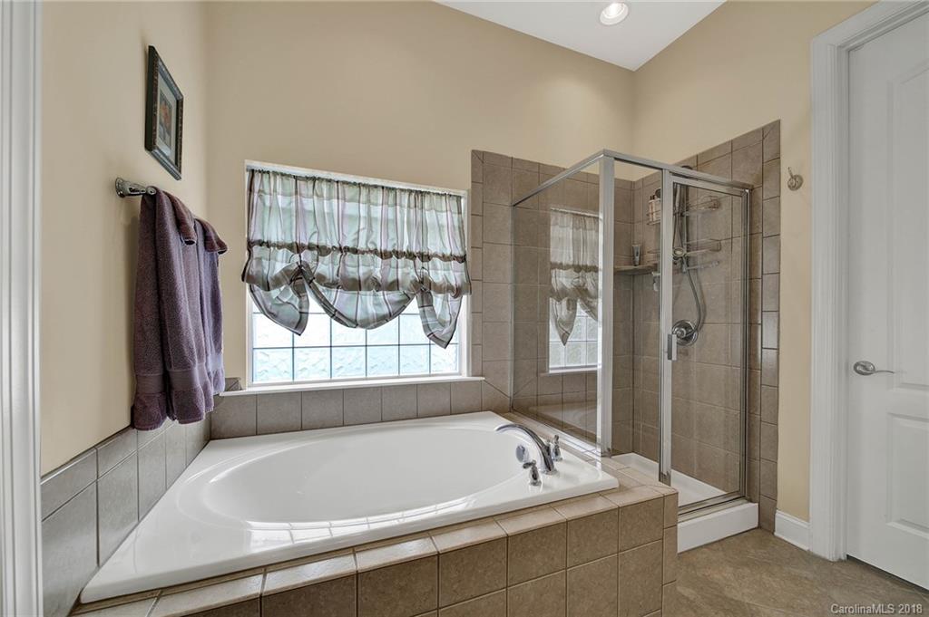 1336 Secret Path Drive Fort Mill, SC 29708 - Photo 16 of 27 a bathroom with a tub and a shower