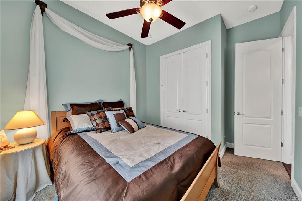 1336 Secret Path Drive Fort Mill, SC 29708 - Photo 18 of 27 a bedroom with a bed and a chandelier