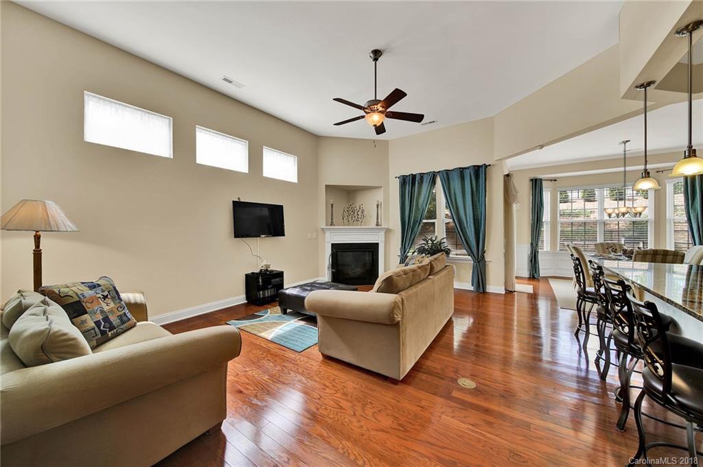 1336 Secret Path Drive Fort Mill, SC 29708 - Photo 10 of 27 a living room with furniture a flat screen tv and a fireplace
