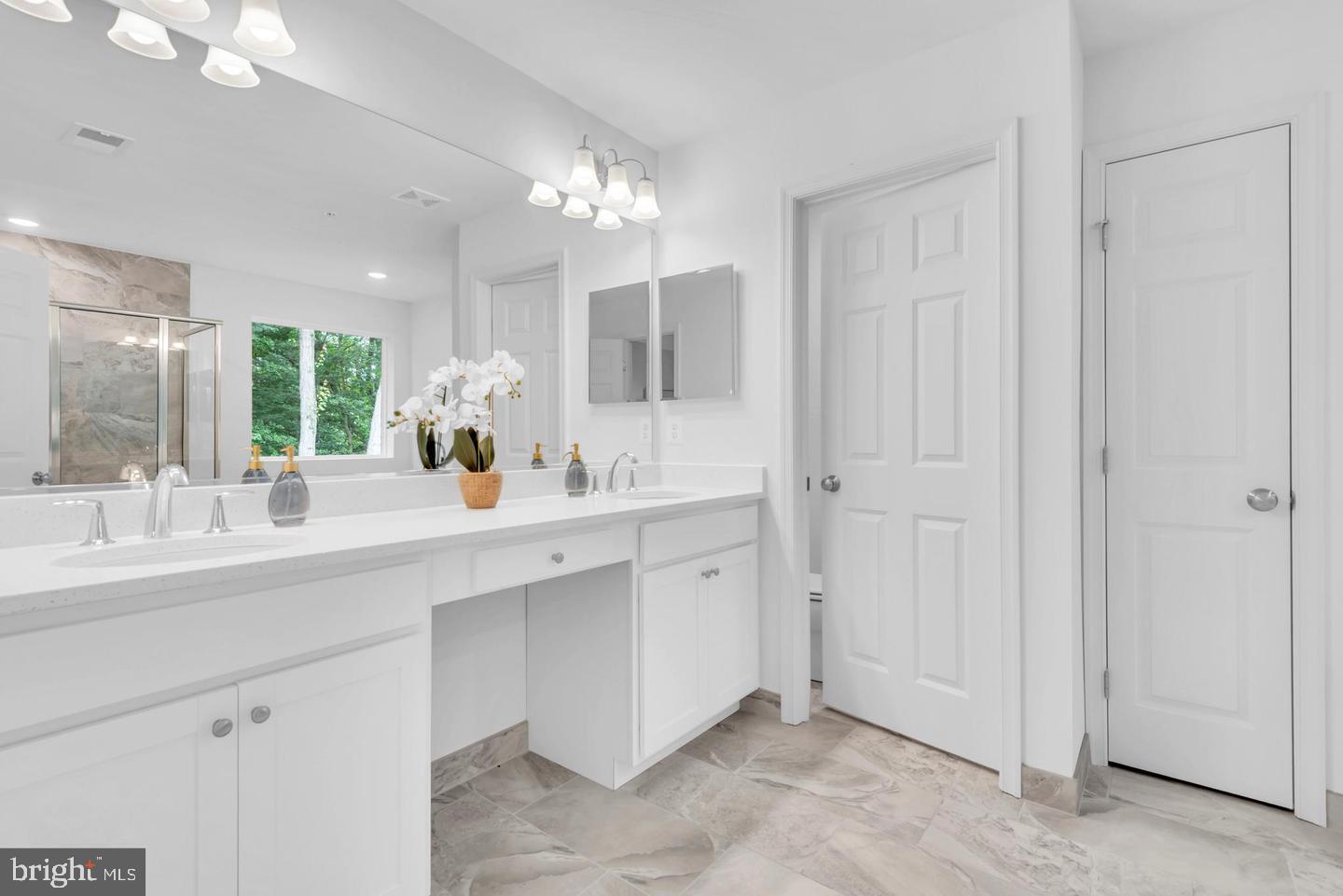 6606 Lost Fox Lane Hanover, MD 21076 - Photo 13 of 19 a bathroom with a double vanity sink and a mirror