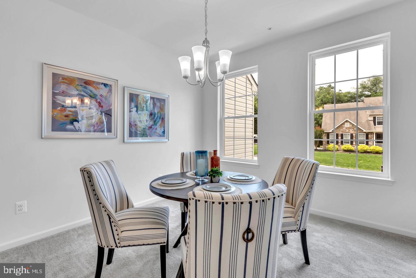 6606 Lost Fox Lane Hanover, MD 21076 - Photo 5 of 19 a dining room with furniture a rug and a large window