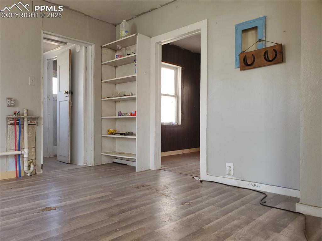 102 South 12th Street Lamar, CO 81052 - Photo 16 of 28 an empty room with wooden floor closet and windows