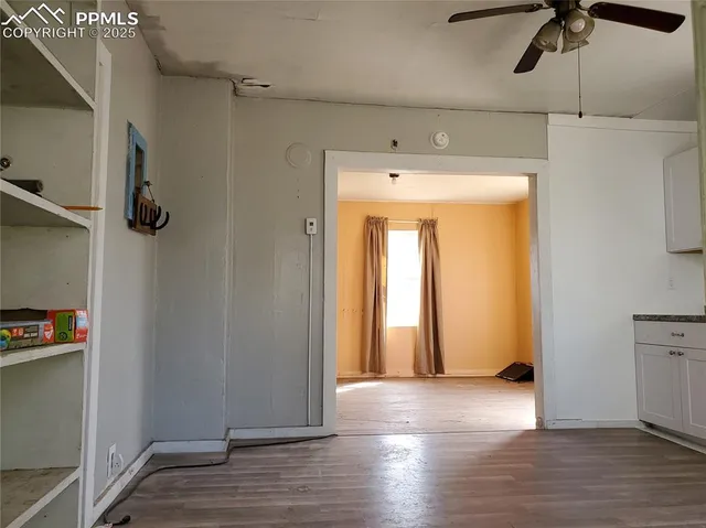 a view of empty room with wooden floor