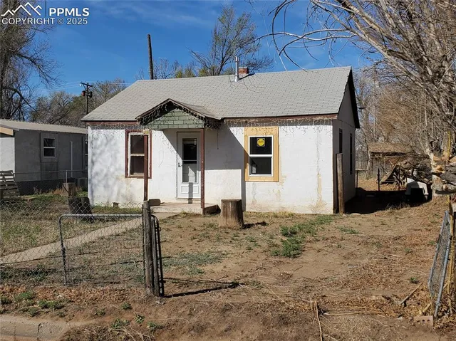a front view of a house with trees