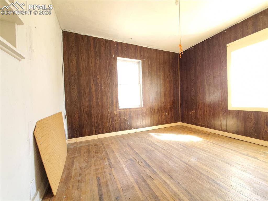 102 South 12th Street Lamar, CO 81052 - Photo 8 of 28 a view of an empty room with wooden floor and a window