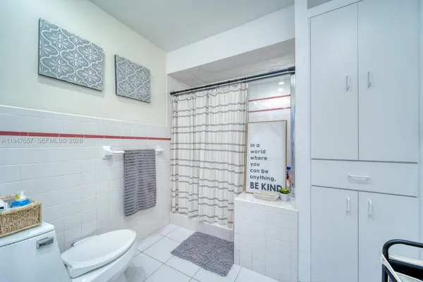 a bathroom with a toilet and shower
