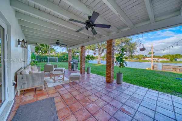 a view of a patio with a table chairs and a backyard