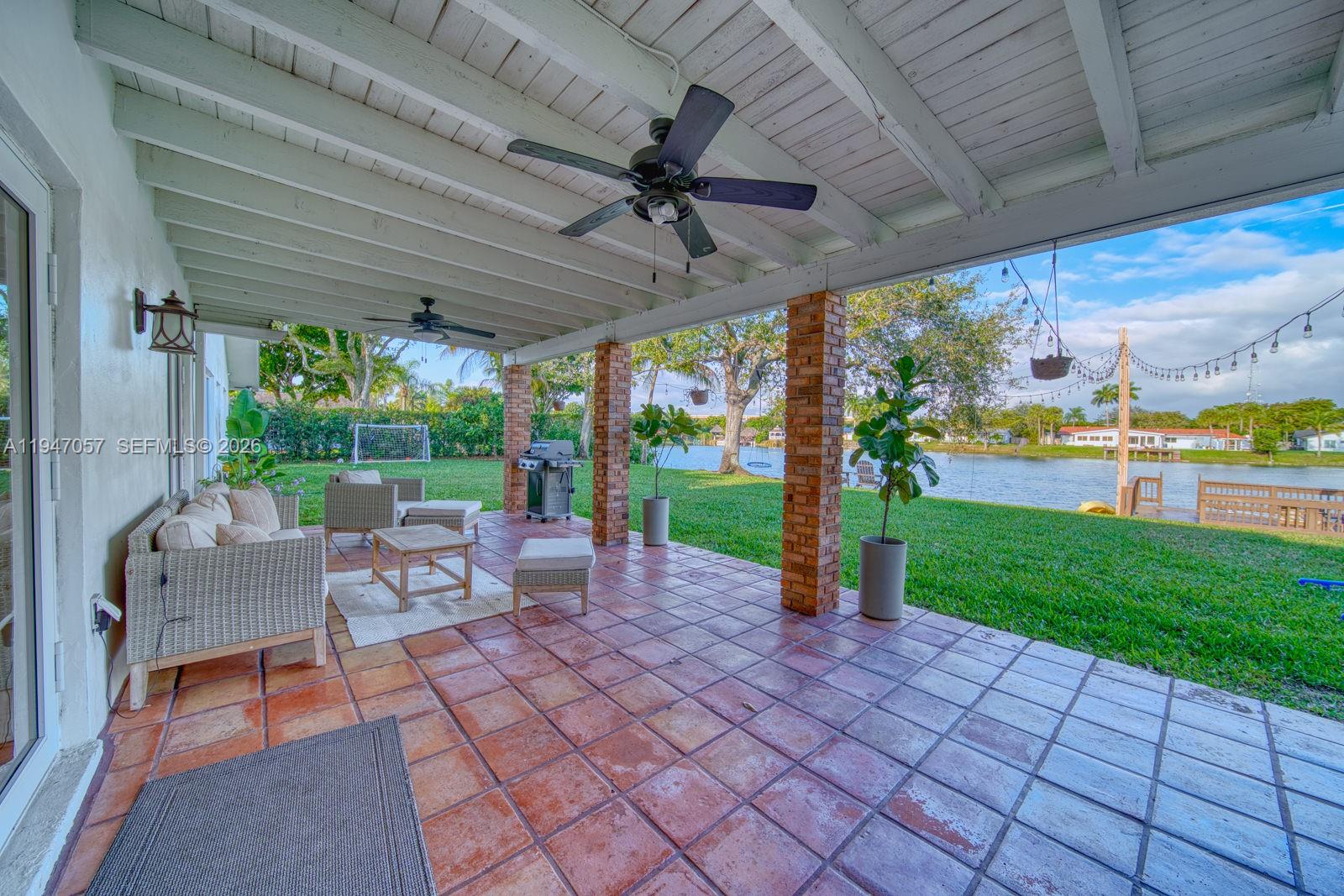 12620 Southwest 114th Avenue Miami, FL 33176 - Photo 27 of 37 a view of a patio with a table chairs and a backyard